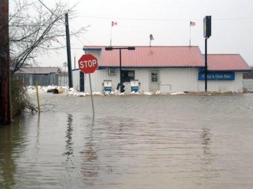 image of small store surrounded by water in flood