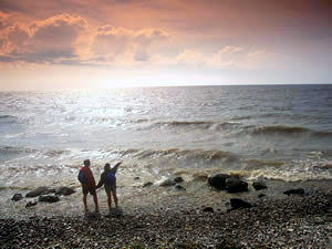 image of 2 people on shores of windy lake 